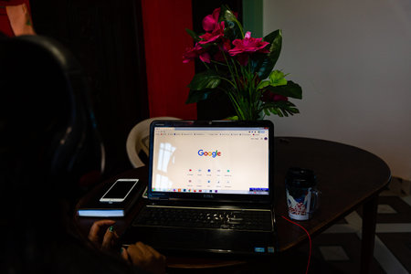 Kathmandu,Nepal - March 30,2020 : Young woman using a laptop to search google in Lockdown Period of...
