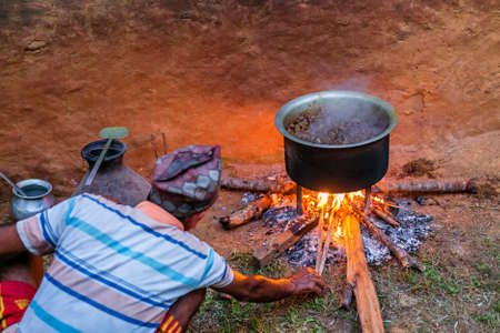Gorkha,Nepal - October 6,2019: Old Man Cooking Mutton Curry in the rural village of Nepal. Mutton Curryのeditorial素材