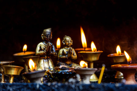 Burning Butter lamps with flames at Buddhist stupa in Kathmandu valley, Nepalの写真素材