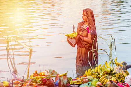 Kathmandu,Nepal - November 1,2019: Hindu devotee offering prayers to sun god standing in water according to hindu rituals during Chhath Puja Festival in Kathmandu. Chath Puja ritualsのeditorial素材