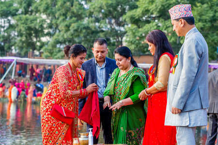kathmandu,Nepal - November 1,2019: Nepalese President Bidhya Devi Bhandari Offering Prayers to Sun god during Chhath Puja Festival in Kathmanduのeditorial素材