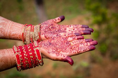 Beautiful Hindu Bride's Hand with Henna Mehendi and Banglesの写真素材