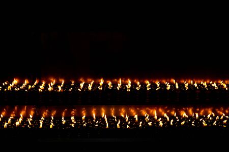 Burning Butter lamps with flames at Swayambhunath stupa in Kathmandu valley, Nepalの写真素材