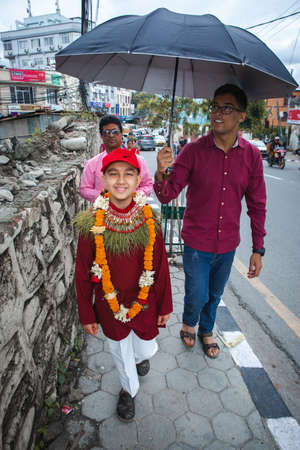 kathmandu,Nepal - June July 6,2019: Hindu Boy returning home from Temple with his maternal uncle during religioius ceremony Bratabandha in Kathmandu.Hindu People.のeditorial素材
