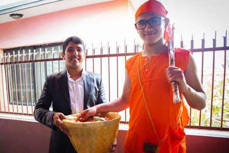Kathmandu,Nepal - June 11,2019: Hindu Holy boy with his maternal uncle during religious ceremony Bratabandha in Kathmandu.Hindu People,Hindu rituals Hindu ritualsのeditorial素材