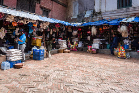 Kathmandu,Nepal - August 16,2019 : Consumer goods for sale at the shop near patan durbar square in kathmandu. Nepali Shopkeeperのeditorial素材