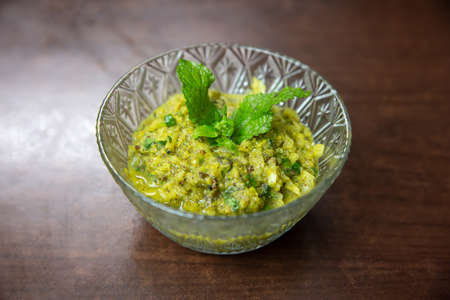 Nepali Style Radish Pickle,Mula ko Achar in a bowl garnished with mint leaves.の写真素材