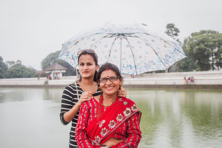 Asian happy mother and daughter traveling outdoors in summer. Family tourism. Asian Nepali women....