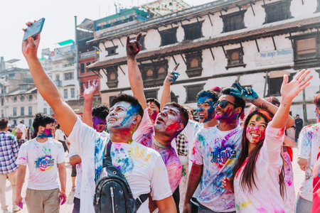 KATHMANDU, NEPAL - MARCH 6, 2023: Tourists enjoying Happy Holi festival at Basantapur Durbar Square in Kathmandu. Holi is a spring festival celebrated as a festival of colours.のeditorial素材