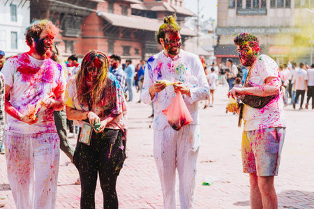 KATHMANDU, NEPAL - MARCH 6, 2023: Tourists enjoying Happy Holi festival at Basantapur Durbar Square in Kathmandu. Holi is a spring festival celebrated as a festival of colours.のeditorial素材
