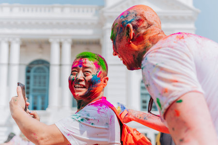 KATHMANDU, NEPAL - MARCH 6, 2023: Tourists enjoying Happy Holi festival at Basantapur Durbar Square...
