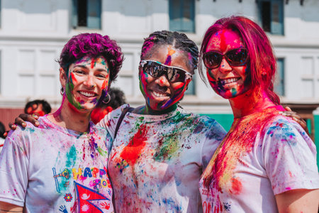 KATHMANDU, NEPAL - MARCH 6, 2023: Tourists enjoying Happy Holi festival at Basantapur Durbar Square in Kathmandu. Holi is a spring festival celebrated as a festival of colours.のeditorial素材