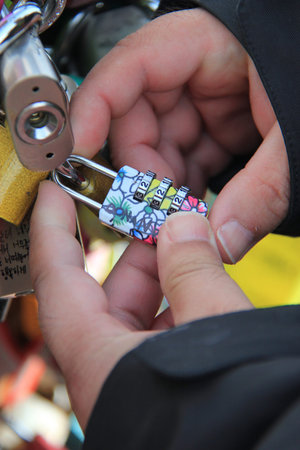 A man is locking a key on the fence on N Seoul Tower as a symbol of promise for their forever loves ...