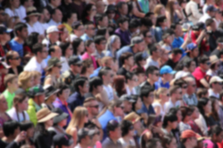 Blurred crowd of audiences on a stadium watching a show.のeditorial素材
