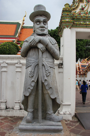 Bangkok, Thailand - May 8, 2015: Stone Sculpture of Western Man beside an entrance of Wat Pho or Temple of Reclining Buddha in Bangkok, Thailand.のeditorial素材
