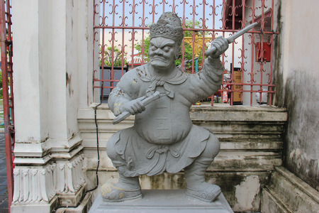 Statue of Chinese Warrior at Wat Arun or Temple of Dawn, Thailand's landmark known for the first light of the morning reflecting off the surface of the temple with pearly iridescence.のeditorial素材