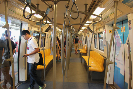Bangkok, Thailand - May 9, 2015: Passengers are getting off Skytrain at its terminal. The Bangkok Mass Transit System, known as BTS system, consists of 34 stations along two lines. Bangkok, Thailand - May 9, 2015: Passengers are getting off Skytrain at its terminal. The Bangkok Mass Transit System, known as BTS system, consists of 34 stations along two lines.