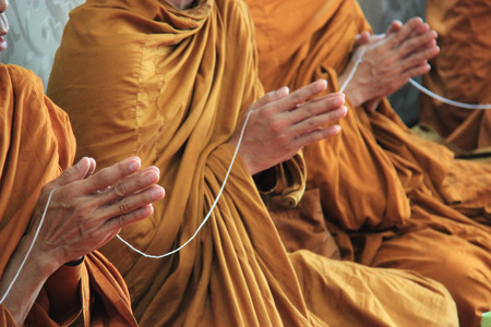 Buddhist monks are praying and blessing people.の写真素材
