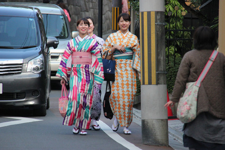 Kyoto, Japan - April 11, 2015: Unidentified Japanese women wear Kimono, beautiful Japanese traditional garment, walking near Temple of the Silver Pavilion in Kyoto, Japan.のeditorial素材