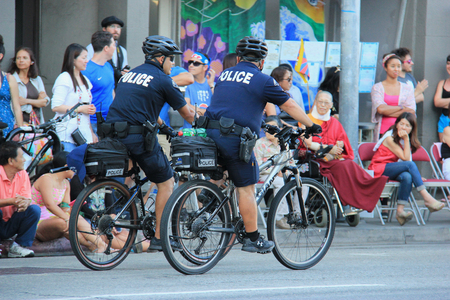 Los Angeles, California, USA - August 16, 2015: Police from Los Angeles Police Department, the third largest municipal police department, patrol during Nisei Week Japanese Festival Parade 2015.のeditorial素材