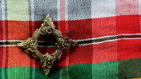 Buang Naka Bas on Thainorth eastern style background with space for write wording, Thai Naka loop amulet, metal amulet for praying and believe of luck, safety, wealthy and protecting dangerous evilの写真素材