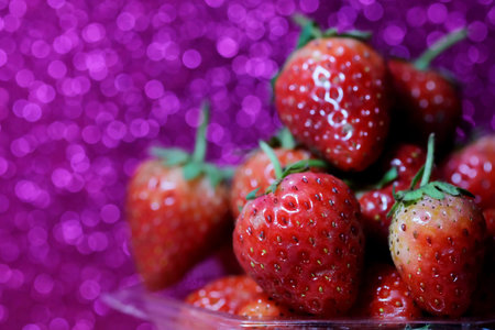 Strawberry on glitter violet background and have space for write wording, sweet romantic fruit for...