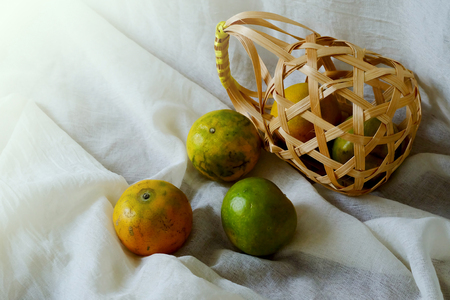 Tangerine in wood basket and space for write wording, delicious high vitamin fruit, useful for health concern or anti-aging group and children because high nutrition and good for digestive systemの写真素材
