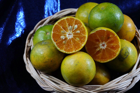 Tangerine in wood basket and space for write wording, delicious high vitamin fruit, useful for health concern or anti-aging group and children because high nutrition and good for digestive systemの写真素材