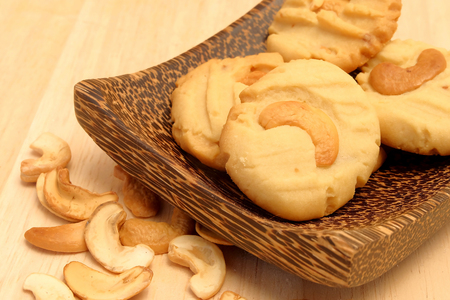 Chocolate chip butter cookie in wood bowl on wood table and space for write wording, delicious snack or dessert, cookie, cake, served with coffee or tea for special celebration or partyの写真素材