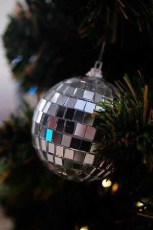 Many colorful shiny mirror balls on an artificial tree in a department store in Christmas and New Year festival and space for write wording, beautiful decoration for promoting to lovers and familyの写真素材