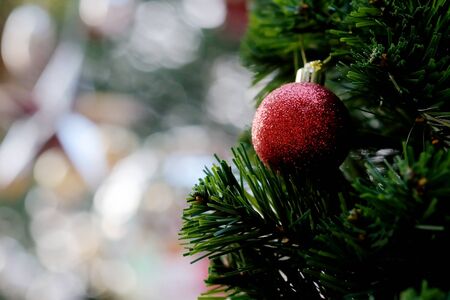 Many colorful shiny mirror balls on an artificial tree in a department store in Christmas and New Year festival and space for write wording, beautiful decoration for promoting to lovers and familyの写真素材