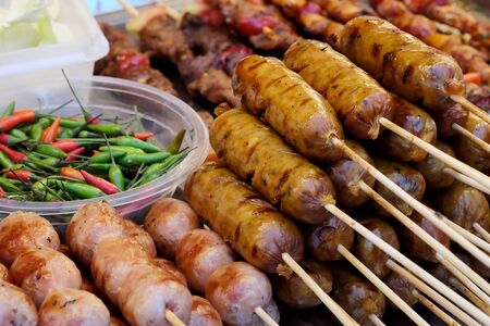 Thai sausage, trendy lifestyle of selling well cooking many kind of street food such as seafood, noodle, roasted pork, meat and chicken ball always found in Bangkok, Thailand and have space for write wordingの写真素材