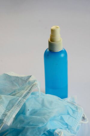Very dangerous, reuse by cleaning used contaminated infection prevention face mask by alcohol and space for write wording, waste management must be highly concerned to reduce virus distribution.の写真素材