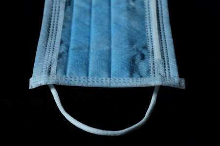 Isolate photo of blue infection preventive face mask and space for write wording. Important tools...