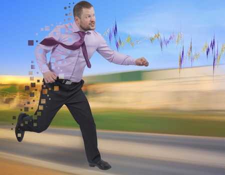 Running businessman in a hurry on blurred backgroundの写真素材