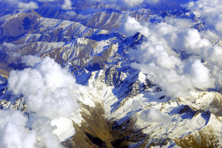 Aerial view of mountains from airplane, clouds, skyの写真素材