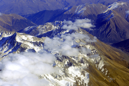 Aerial view of mountains from airplane, clouds, skyの写真素材