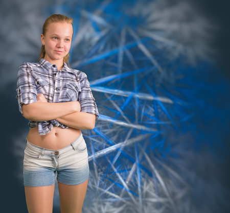 Teen girl standing with cross hands on abstract background with fractalsの写真素材