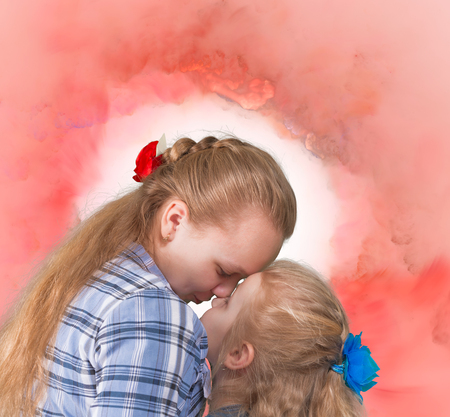 Senior and junior sisters embracing and kissing on abstract backgroundの写真素材