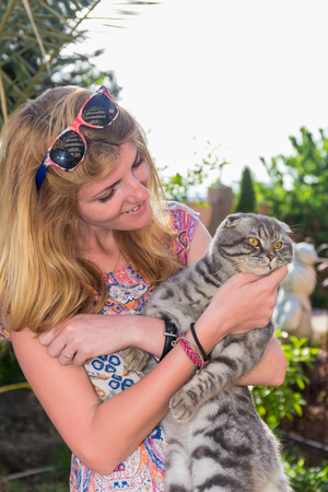 Portrait of beautiful young woman with the catの写真素材