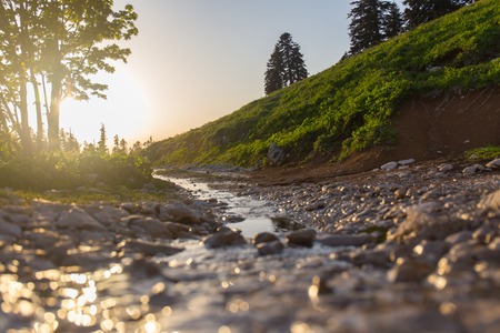 Highland's stream in rays of light mountain riverの写真素材
