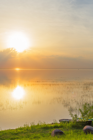 Sunset over water lake sun reflection summerの写真素材