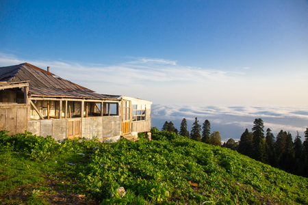 Huts in highlands over the clouds mountainsの写真素材