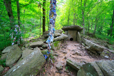 Dolmen at the forest ancient prehistoric building treeの写真素材
