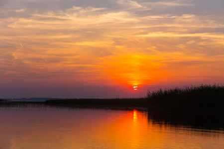 Colorful sunset over the lake with beautiful skyの写真素材