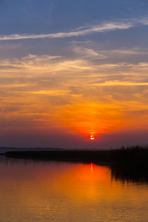 Colorful sunset over the lake with beautiful skyの写真素材