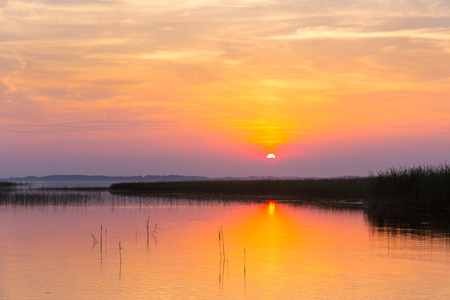 Colorful sunset over the lake with beautiful skyの写真素材