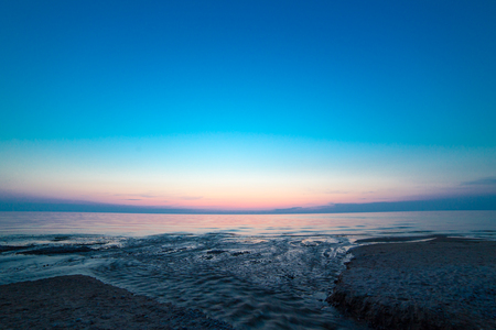 Night sea water right after colorful sunsetの写真素材
