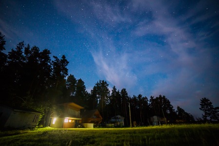 Night scene with small cottages and stars in the skyの写真素材