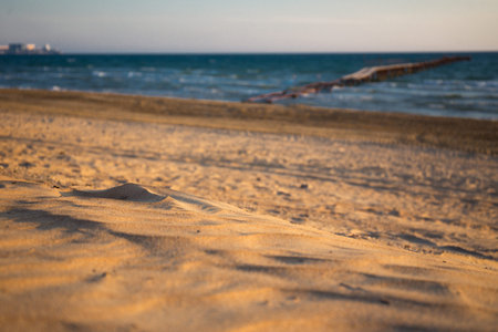 Sand on the beach with old pier on background